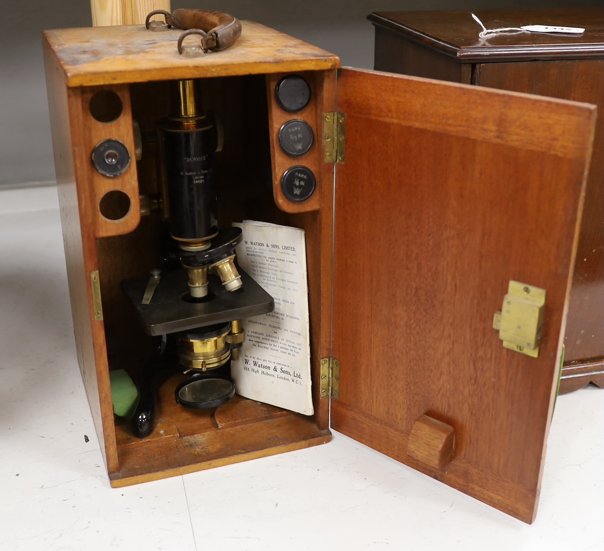 A mahogany cased 'service' microscope, marked W. Watson & Son Ltd., London and numbered 34429, with alternative lens in fitted compartments, case 34cm high